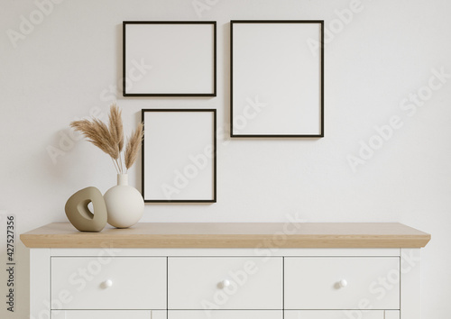 Three 8x10 Vertical and Horizontal Black Frame mockup on with decorations on white wall. 3D Rendering