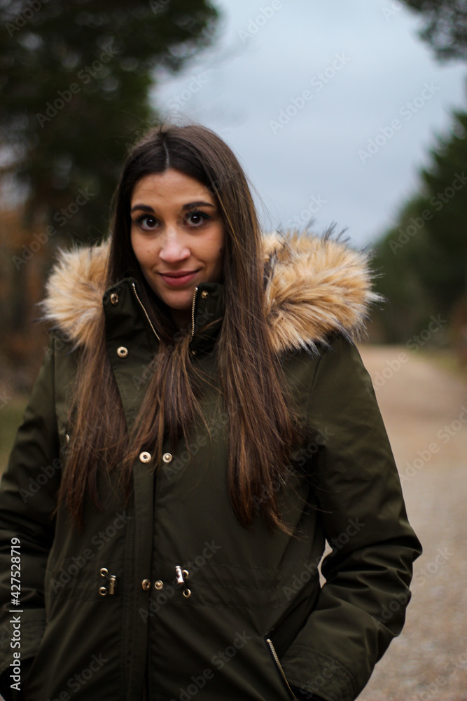 young and beautiful woman smiling happily in a forest young and beautiful woman smiling happily in a forest