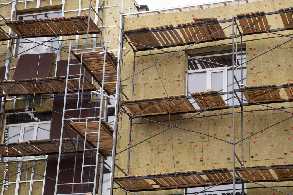 Fototapeta premium Thermal insulation of a multi-storey building with special materials.