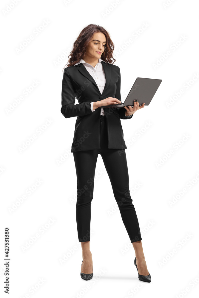 Full length portrait of a young businesswoman holding a laptop computer Full length portrait of a young businesswoman holding a laptop computer