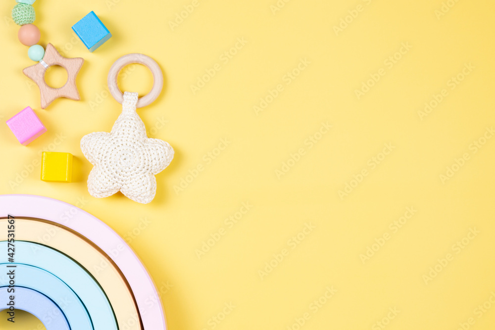 Baby kid toys on yellow background. Sustainable early childhood