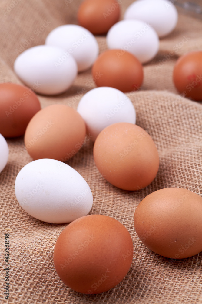 Many white and brown chicken eggs. Many white and brown chicken eggs.