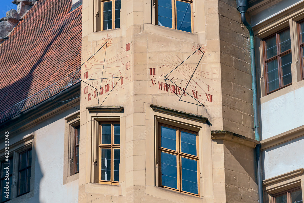antique sundial on the wall of a house in the small German town of Rothenburg ob der Tauber