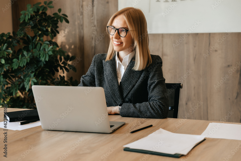 A young successful business woman sits at a workplace in her office as a company director. Business center worker A young successful business woman sits at a workplace in her office as a company director. Business center worker
