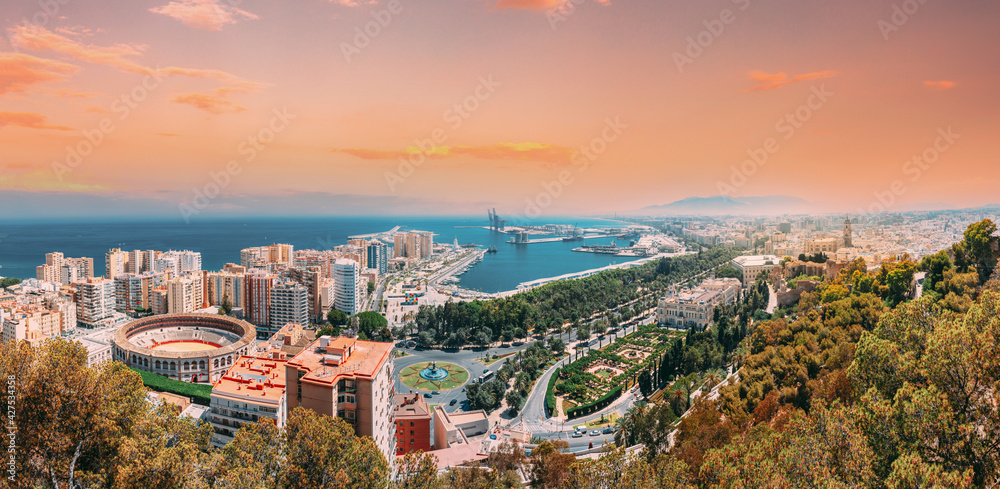 Malaga, Spain. Panorama Cityscape Elevated View Of Malaga In Sunny Summer Evening. Altered Sunset Sky