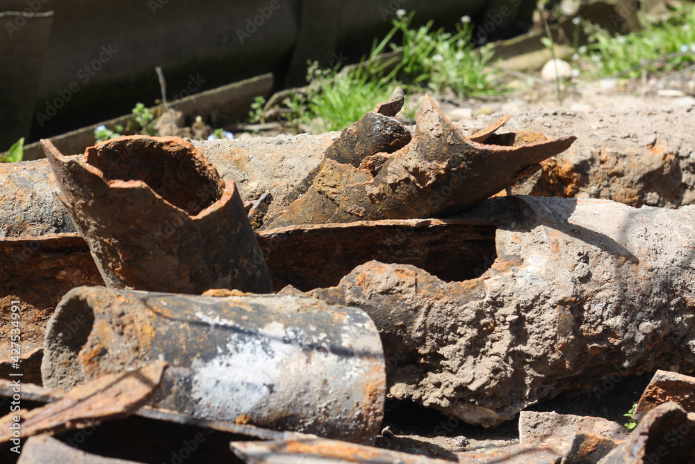 Old drain pipes lying outdoors under the sunshine. Horizontal image Old drain pipes lying outdoors under the sunshine. Horizontal image