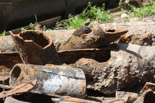 Old drain pipes lying outdoors under the sunshine. Horizontal image