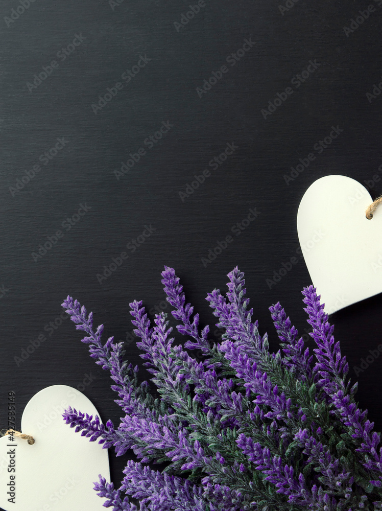 heart and a branch of artificial lavender on a dark background. Space for text.