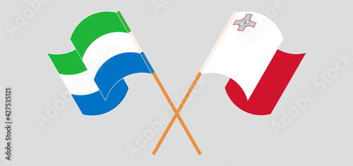 Crossed and waving flags of Sierra Leone and Malta