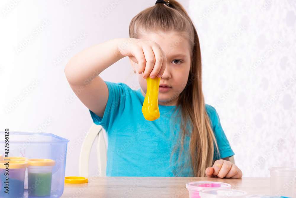 A blonde child is playing with a slime. Little beautiful caucasian girl is playing with many slimes. Play Slime Toy A blonde child is playing with a slime. Little beautiful caucasian girl is playing with many slimes. Play Slime Toy