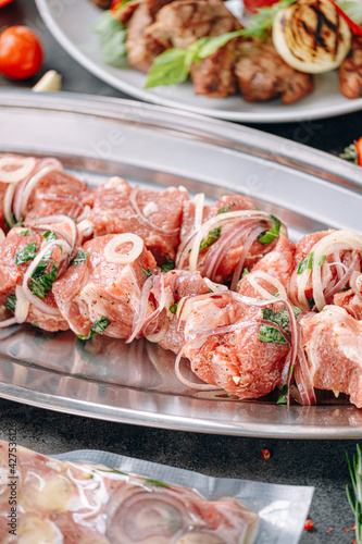 marinated meat for barbecue. vacuum-packed and marinated meat, meat on a skewer and ready-made grilled meat with sauce on a plate