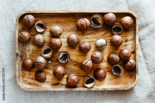Top view of macadamia nuts on a wooden bowl