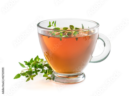 Black tea with thyme in glass cup isolated on white