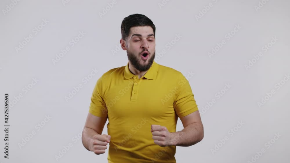 Man is very glad and happy, he shows yes gesture of victory, guy achieved result, goals. Surprised excited lucky bearded guy on white background. Jackpot concept. Man is very glad and happy, he shows yes gesture of victory, guy achieved result, goals. Surprised excited lucky bearded guy on white background. Jackpot concept.