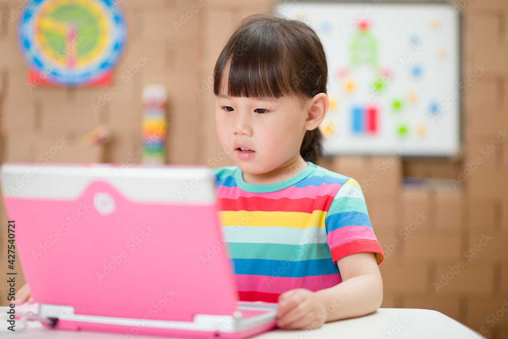 young girl using laptop for online learning during lockdown time young girl using laptop for online learning during lockdown time