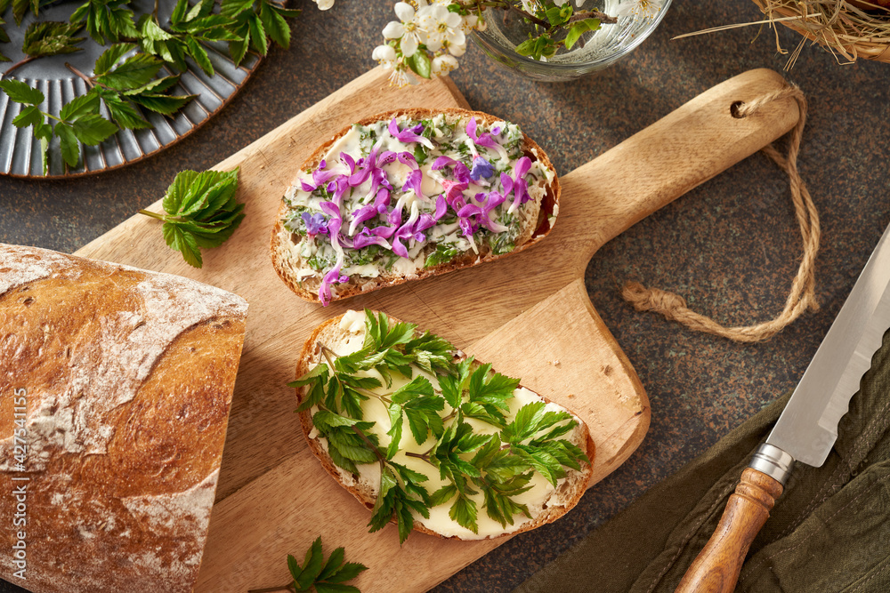 Sourdough bread with wild edible spring plants - young goutweed leaves, purple dead-nettle and lungwort flowers Sourdough bread with wild edible spring plants - young goutweed leaves, purple dead-nettle and lungwort flowers