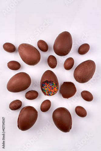 Collection of chocolate eggs on white surface.