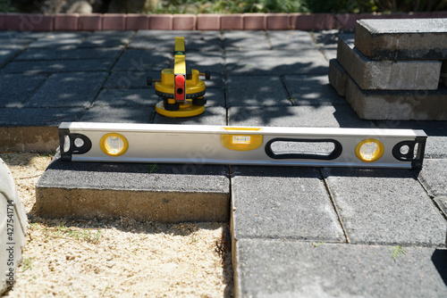 Spirit level for laying flagstone in the garden. laser spirit level in the background 