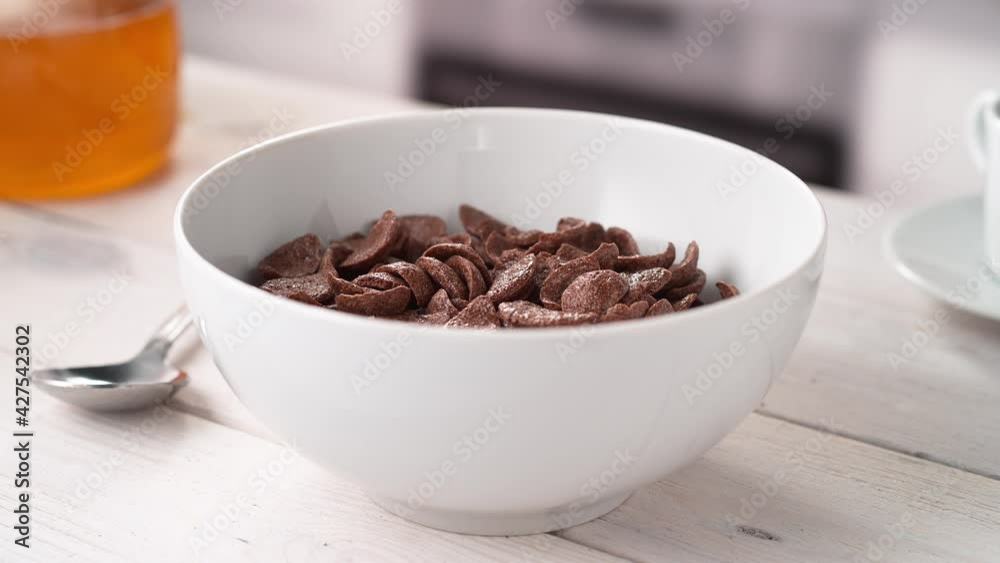 Pouring Milk into White Bowl Full of Cocoa Shell-Shaped Cereals in Slow Motion (Phantom Flex) Pouring Milk into White Bowl Full of Cocoa Shell-Shaped Cereals in Slow Motion (Phantom Flex)