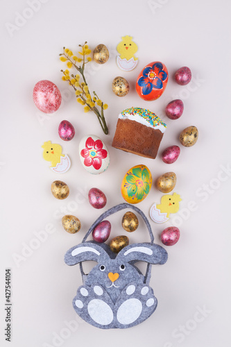 Flat lay easter symbols on white background.