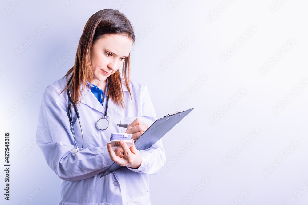 beautiful medical woman writing a report on folder with caliper. medical report concept with space for copy beautiful medical woman writing a report on folder with caliper. medical report concept with space for copy