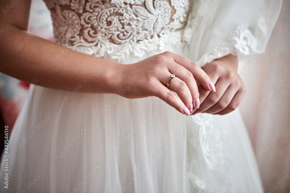 Morning of the bride when she wears a beautiful dress, woman getting ready before wedding ceremony Morning of the bride when she wears a beautiful dress, woman getting ready before wedding ceremony