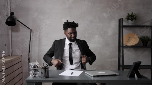 black business man comes to work in the office. The begining of the work day