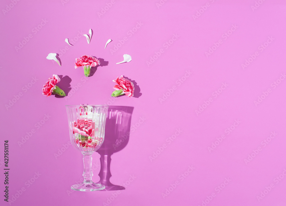 Spring colorful flowers in a wine glass on bright lilac background. Minimal spring concept. Nature background idea. Spring colorful flowers in a wine glass on bright lilac background. Minimal spring concept. Nature background idea.