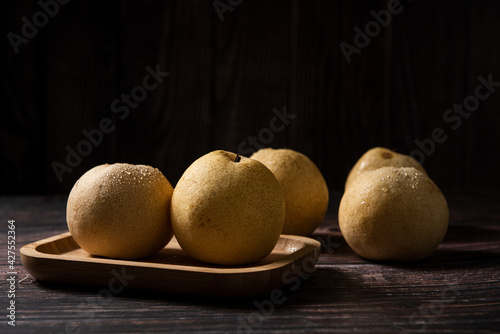 close-up of  fresh yellow pear on a wooden table