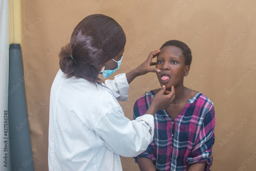 Fototapeta premium African female nurse , doctor or medical specialist checking a lady patient for health reasons, and also has stethoscope with her 