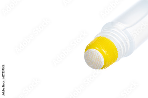 Paper glue with a yellow cap, isolated on white background.
