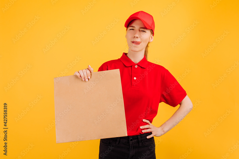 Delivery service worker holding a paper bag with food on an isolated yellow background. Delivery service worker holding a paper bag with food on an isolated yellow background.