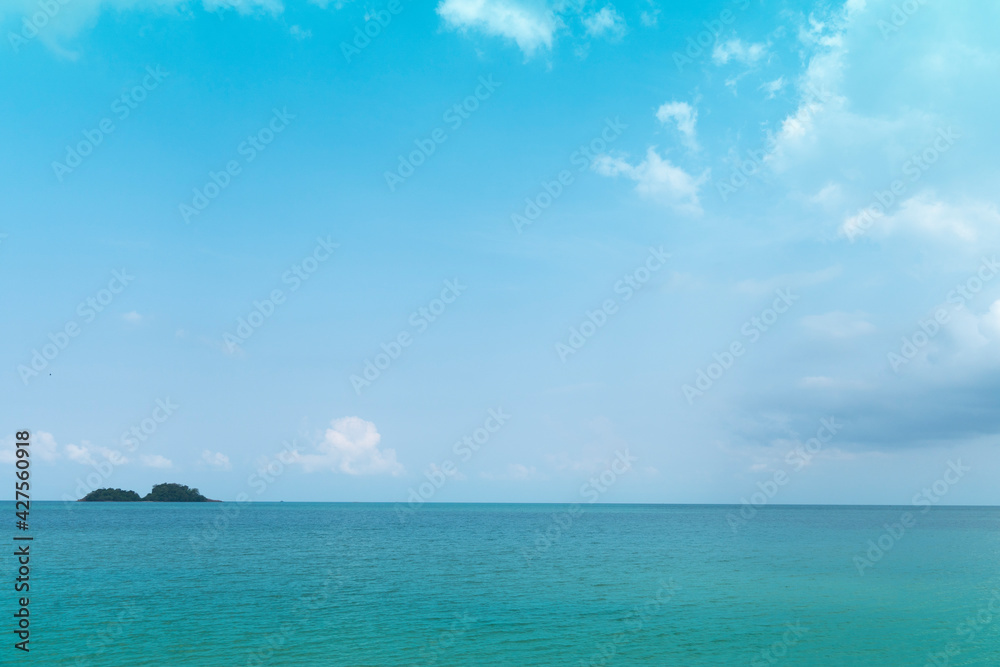 Light waves on the turquoise sea and distant islands. for seascape background.
