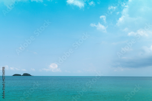 Light waves on the turquoise sea and distant islands. for seascape background.