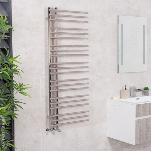 Metallic heated towel rack in a modern renovated bathroom