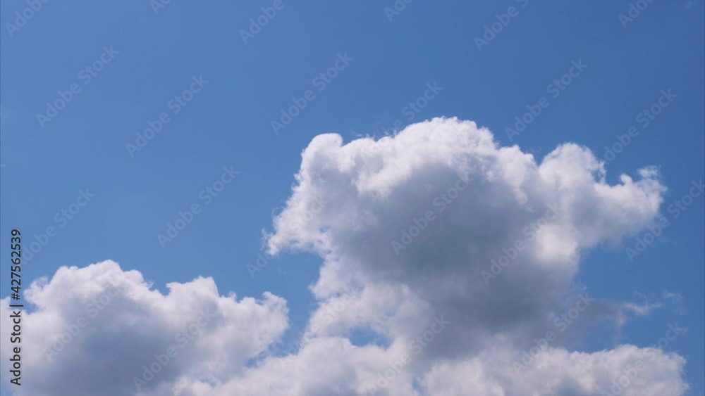 Time lapse of rolling puffy clouds are moving, white clouds time lapse. Clouds running across the blue sky. 4k Timelapse of white clouds with blue sky background. Time lapse of rolling puffy clouds are moving, white clouds time lapse. Clouds running across the blue sky. 4k Timelapse of white clouds with blue sky background.