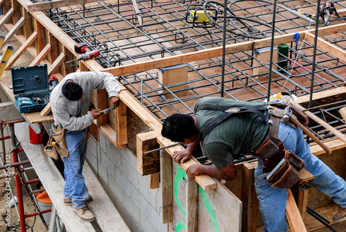 Carpenters setting wood forms on a new deck