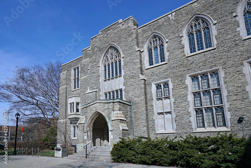Gothic style stone college building with leaded glass windows