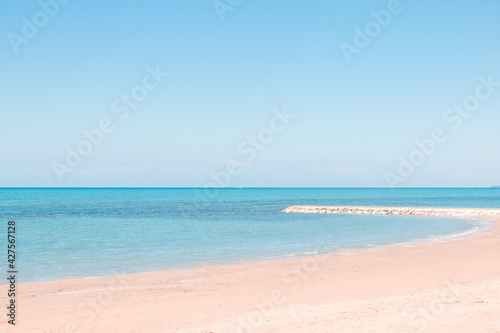 Beautiful landscape with white sand beach. Panoramic view on blue sky and azure coast sea on natural background. Luxury summer vacation © lara-sh