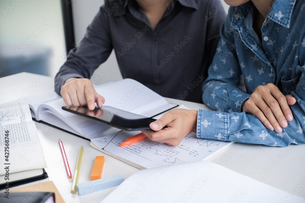 College Student People learning education studying examining Tutor doing homework with teacher trainer education concept. College Student People learning education studying examining Tutor doing homework with teacher trainer education concept.
