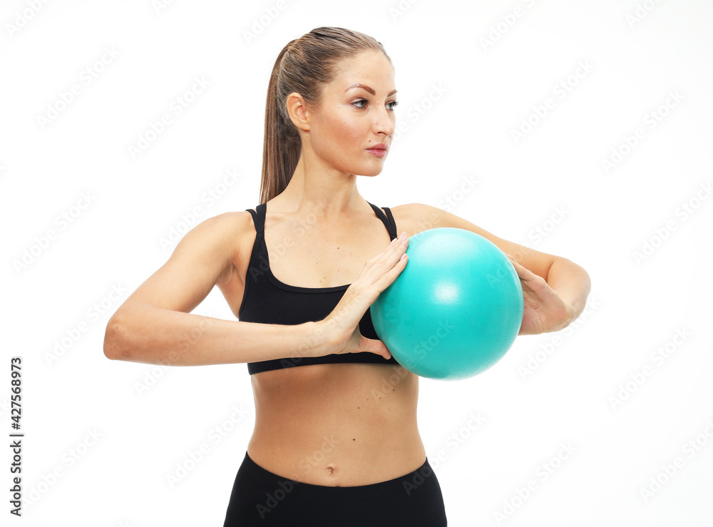 Young fit adult woman doing yoga exercise workout with gymnastics ball. Young fit adult woman doing yoga exercise workout with gymnastics ball.