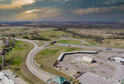 High drone view above highways, interchanges the roads on interstate takes you on a fast transportation highway in Stroud Oklahoma USA