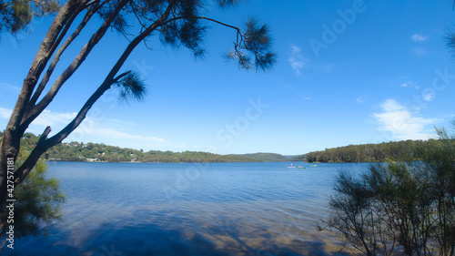 Beautiful view of people kayaking afar on the Narrabeen Lakes at Sydney Australia, Northern Beaches photo