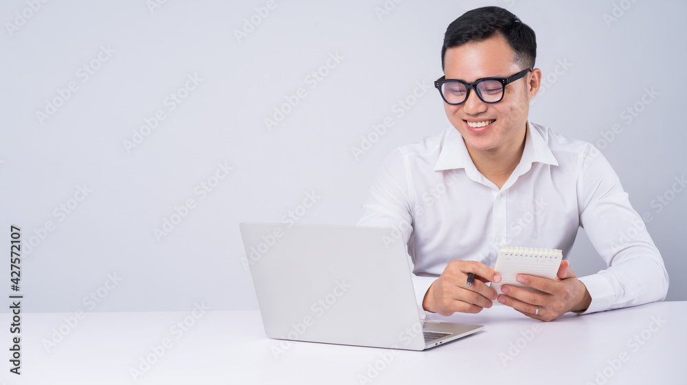 Asian businessman using laptop on white background Asian businessman using laptop on white background