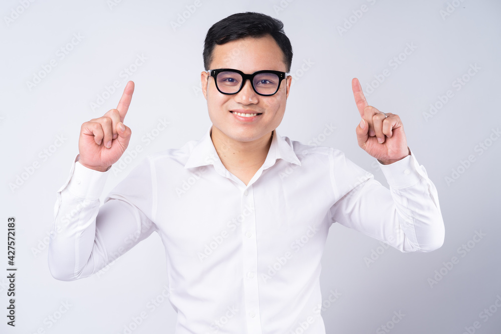 Image of Asian businessman pointing up