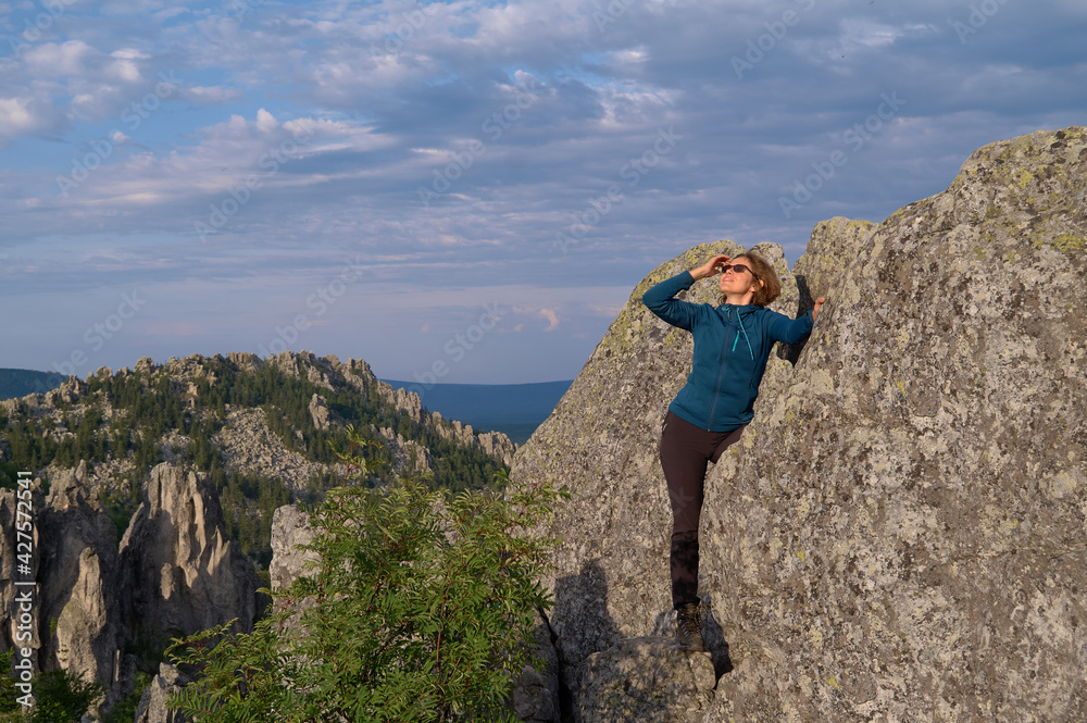 Happy emotions of a female tourist on the top of a cliff Happy emotions of a female tourist on the top of a cliff