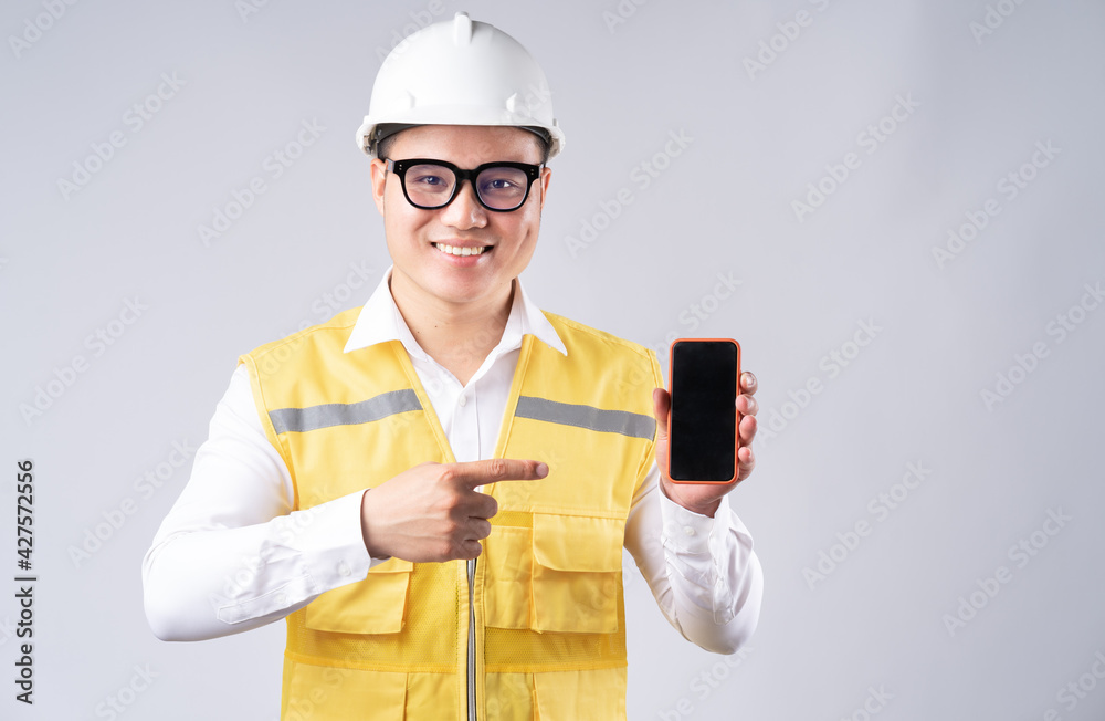 The Asian engineer was pointing at the phone screen The Asian engineer was pointing at the phone screen