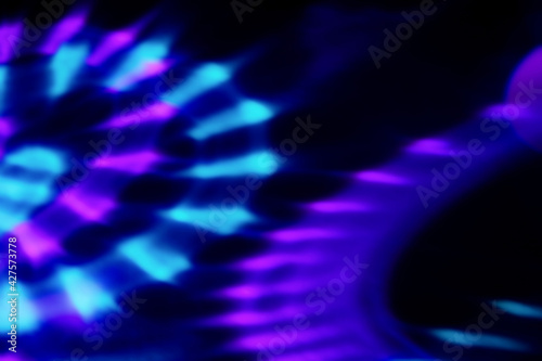 Blur colorful neon light leaks on black background. Defocused illuminated abstract futuristic texture for using over photos as overlay or screen filter
