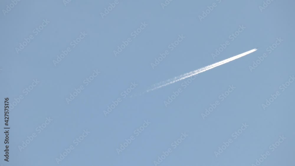 An airplane trail across the sky. Aircraft leave a diagonal trail across a clear blue sky.
An airplane trail across the sky. Aircraft leave a diagonal trail across a clear blue sky.