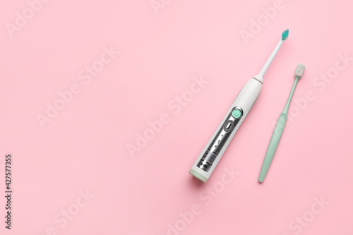 Different tooth brushes on color background